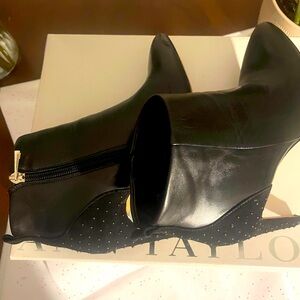 Black high heel pointy dress boots.